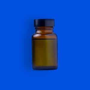 bottle of ghb on blue background