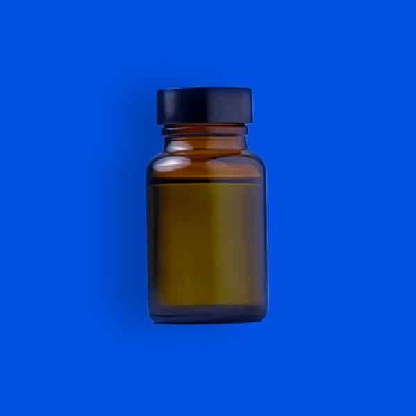 bottle of ghb on blue background