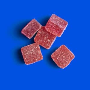 MDMA gummies on blue background